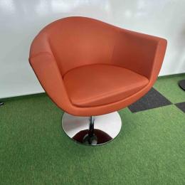 Orange armchair on silver leg